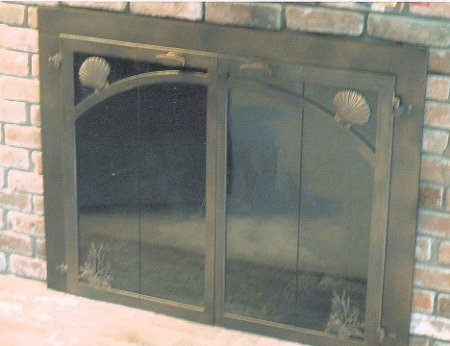 pollock rip fireplace doors with shell and sea grass motif all architectural bronze finish vice bi fold doors, smoke glass and slide mesh